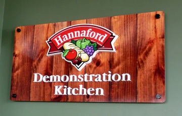 DiBond sign with digital woodgrain print and raised pvc graphics for Dempsey Center