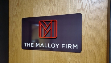 Dibond sign with vinyl letters and 1/2" thick acrylic logo, mounted on door