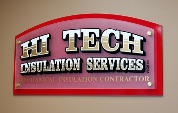 Vinyl lettering on frosted acrylic panel mounted with 1" stand-offs on red pvc panel