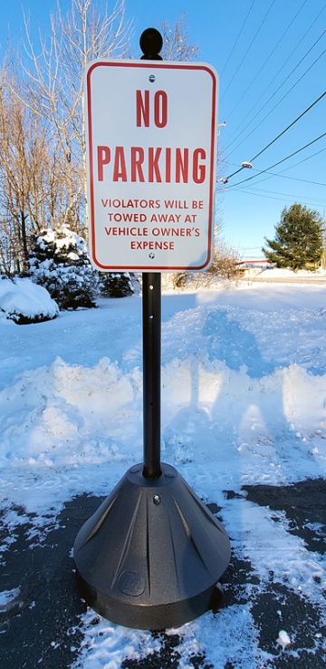 Moveable parking lot sign with wheels