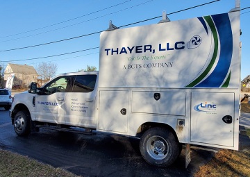Vinyl lettering and printed grasphics on a Thayer, LLC utility body truck